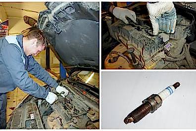 Мастер меняет свечи во время ТО на БМВ