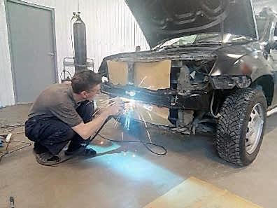 Автомеханик восстанавливает геометрию кузова в сервисе Санрено